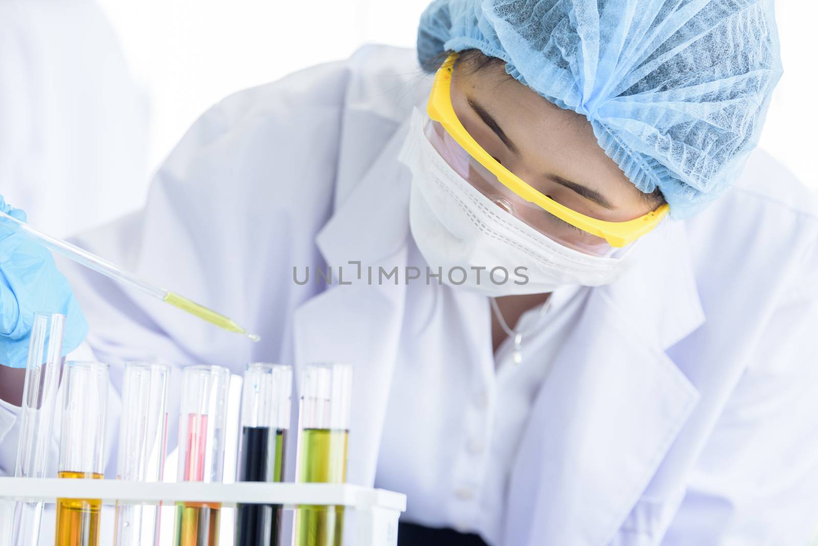 Asian young girl student scientist researching  and learning in a laboratory.