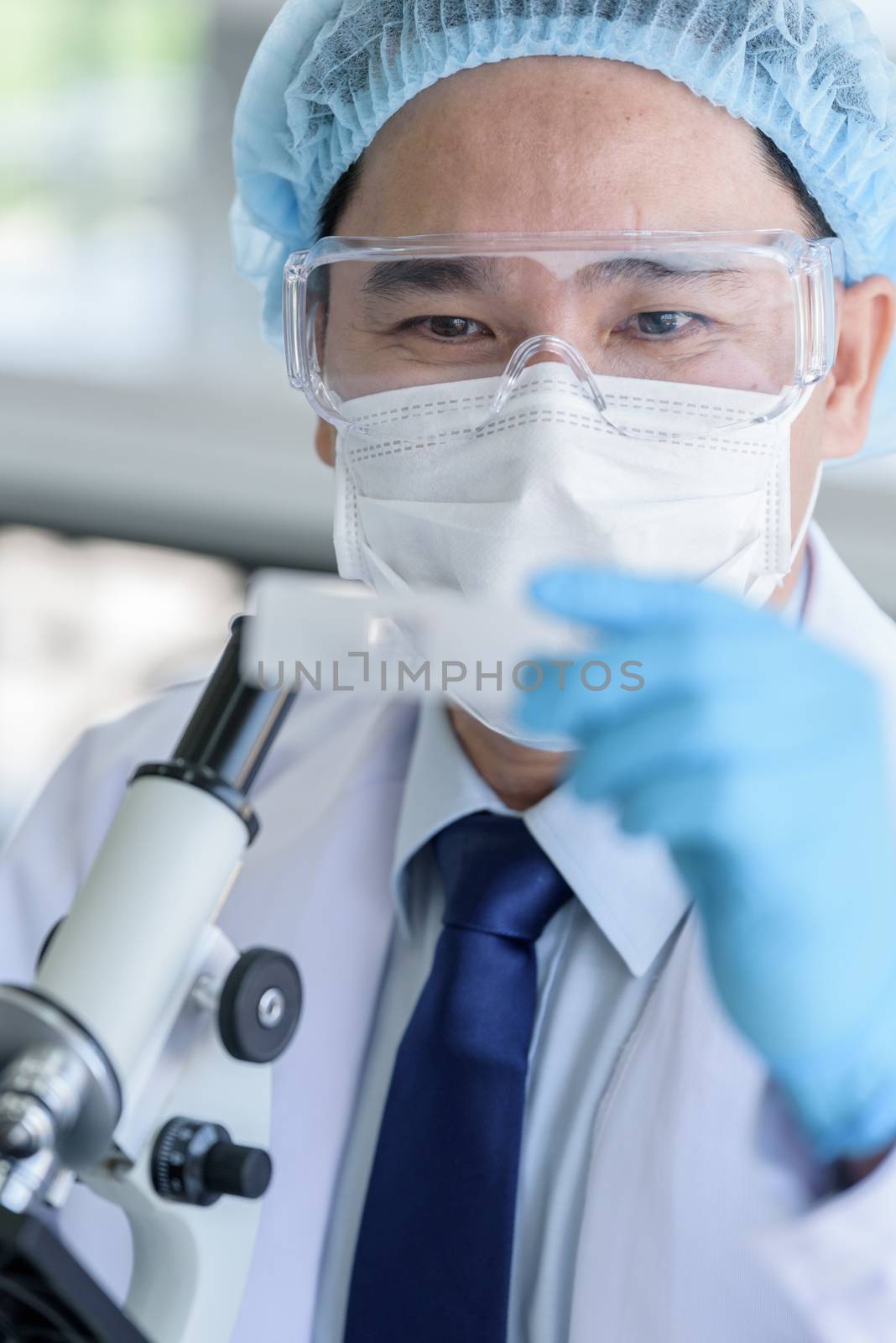 Asian man scientist researching  and learning in a laboratory.