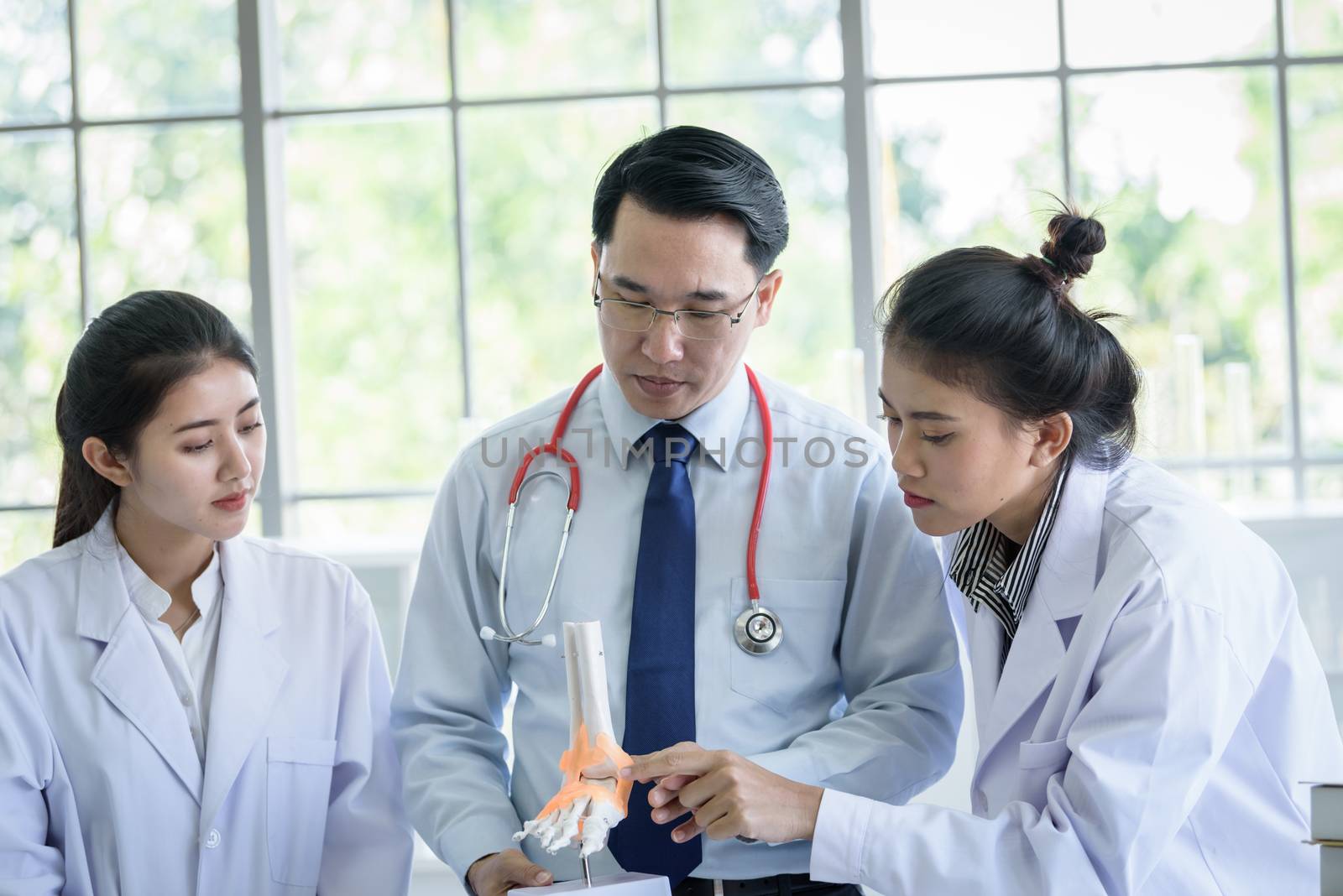 Asian teacher has teaching to student about science and anatomical in laboratory