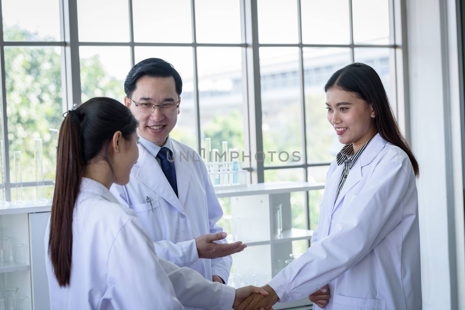 Asian scientist team have meeting in laboratory.