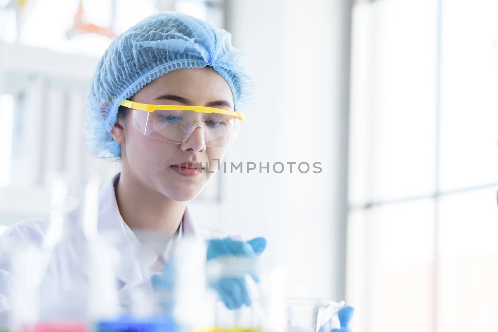 Asian young girl student scientist researching  and learning in a laboratory.