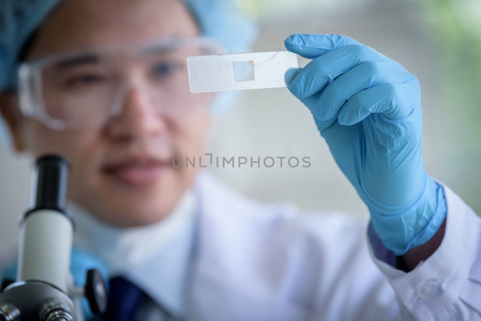 Asian man scientist researching  and learning in a laboratory.