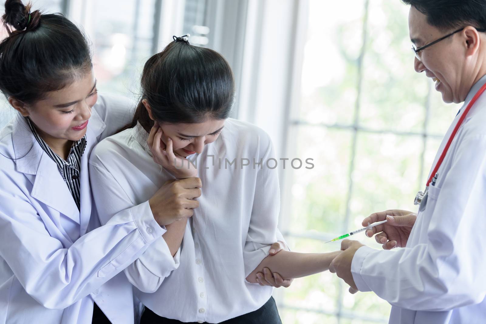 Patient has afraid and scary of syringe and needle. by animagesdesign