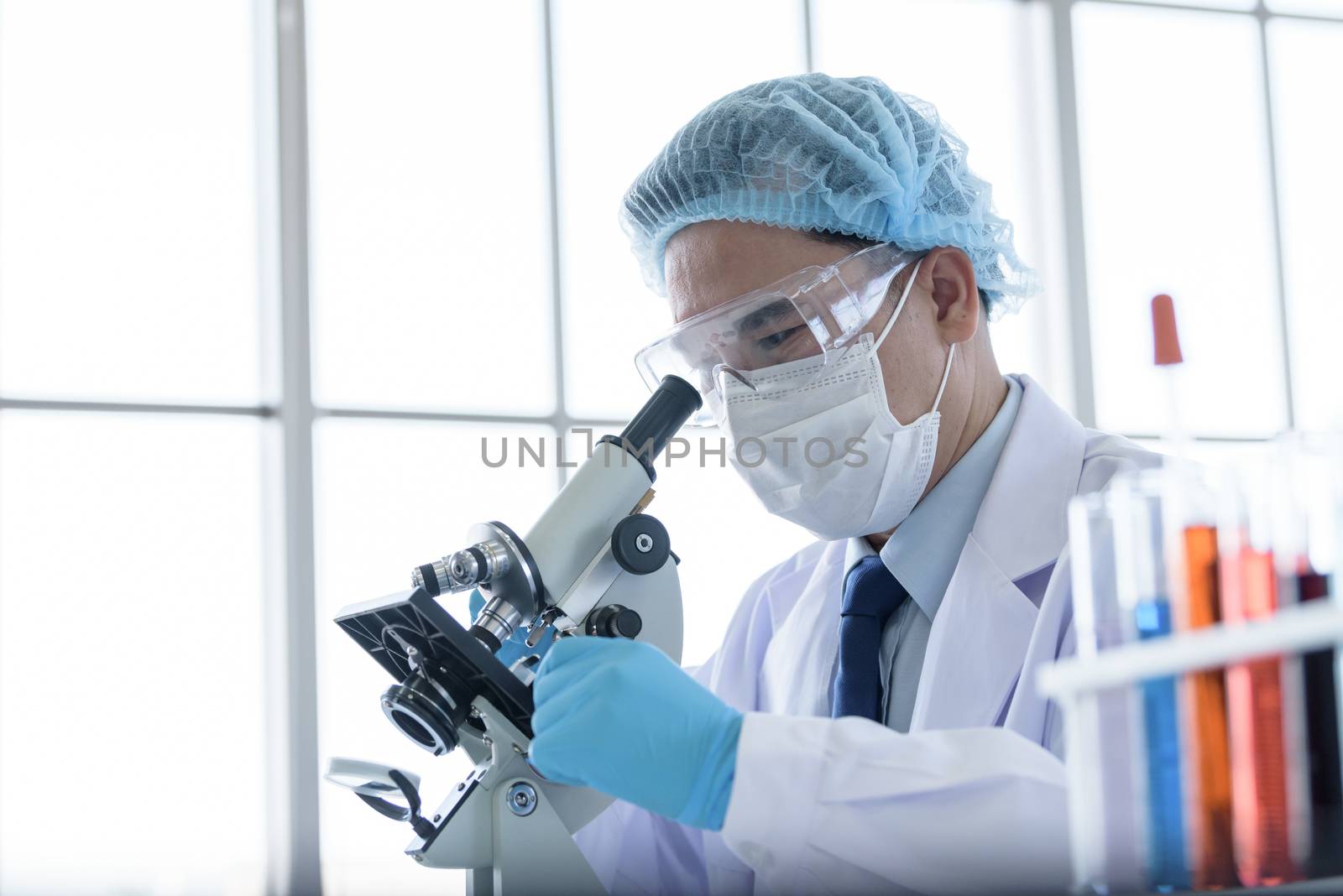 Asian man scientist researching  and learning in a laboratory. by animagesdesign