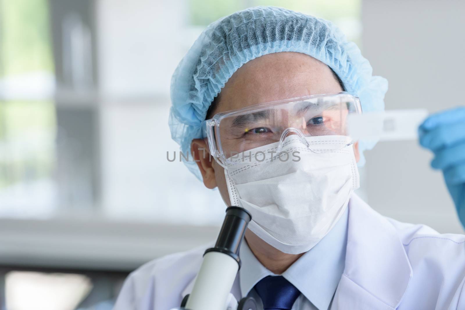 Asian man scientist researching  and learning in a laboratory.