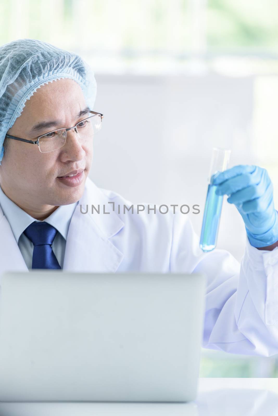 Asian senior scientist male researching and learning in a laboratory.