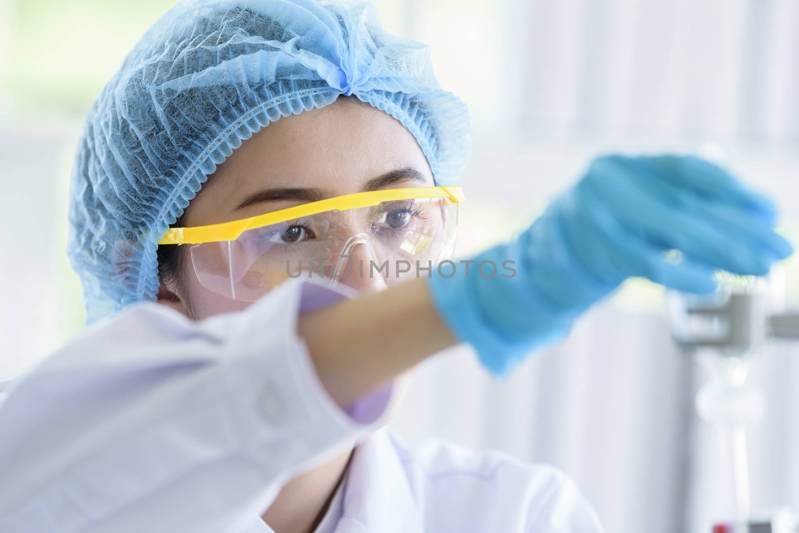 Asian young girl student scientist researching  and learning in a laboratory.