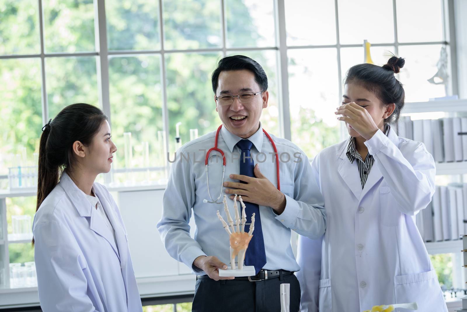 Asian teacher has teaching to student about science and anatomical in laboratory