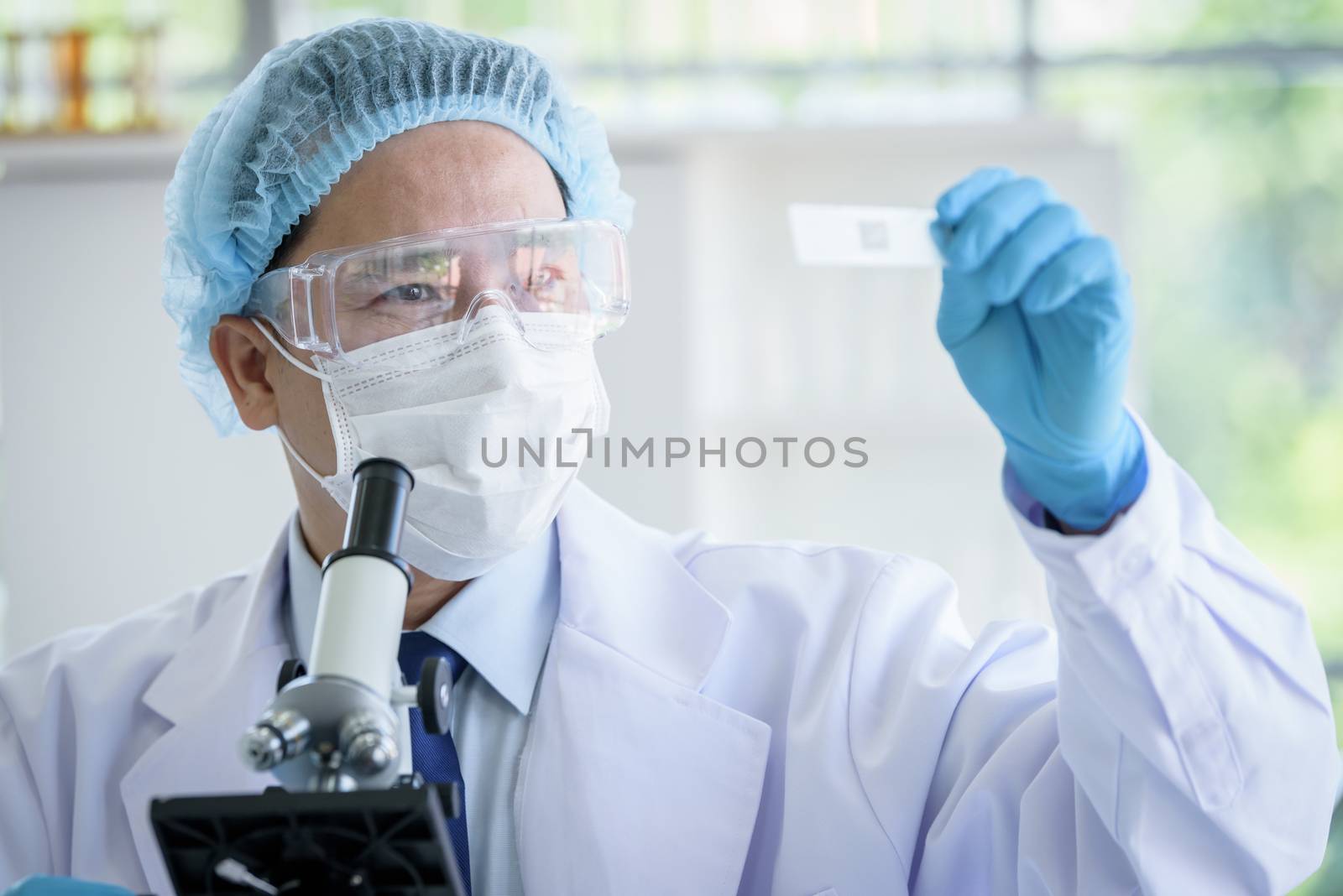 Asian man scientist researching  and learning in a laboratory.