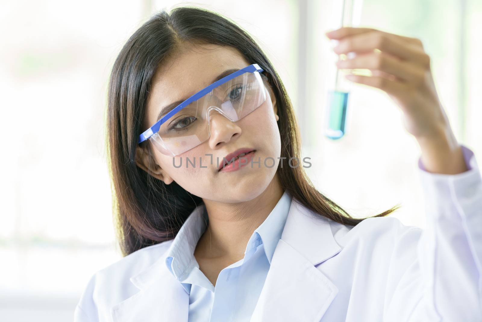 Asian young girl student scientist researching  and learning in a laboratory.