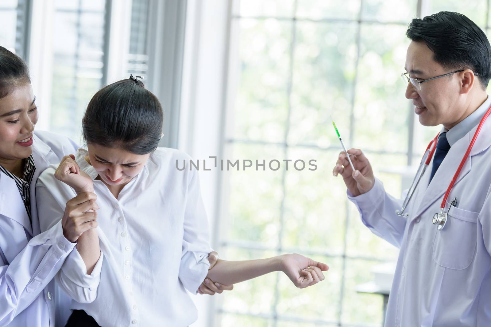 Patient has afraid and scary of syringe and needle. by animagesdesign