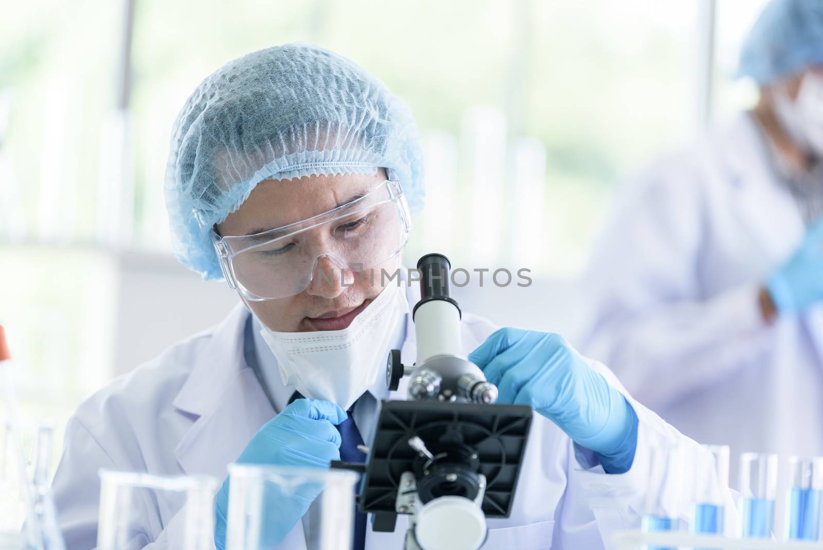 Asian scientist team has researching in laboratory.