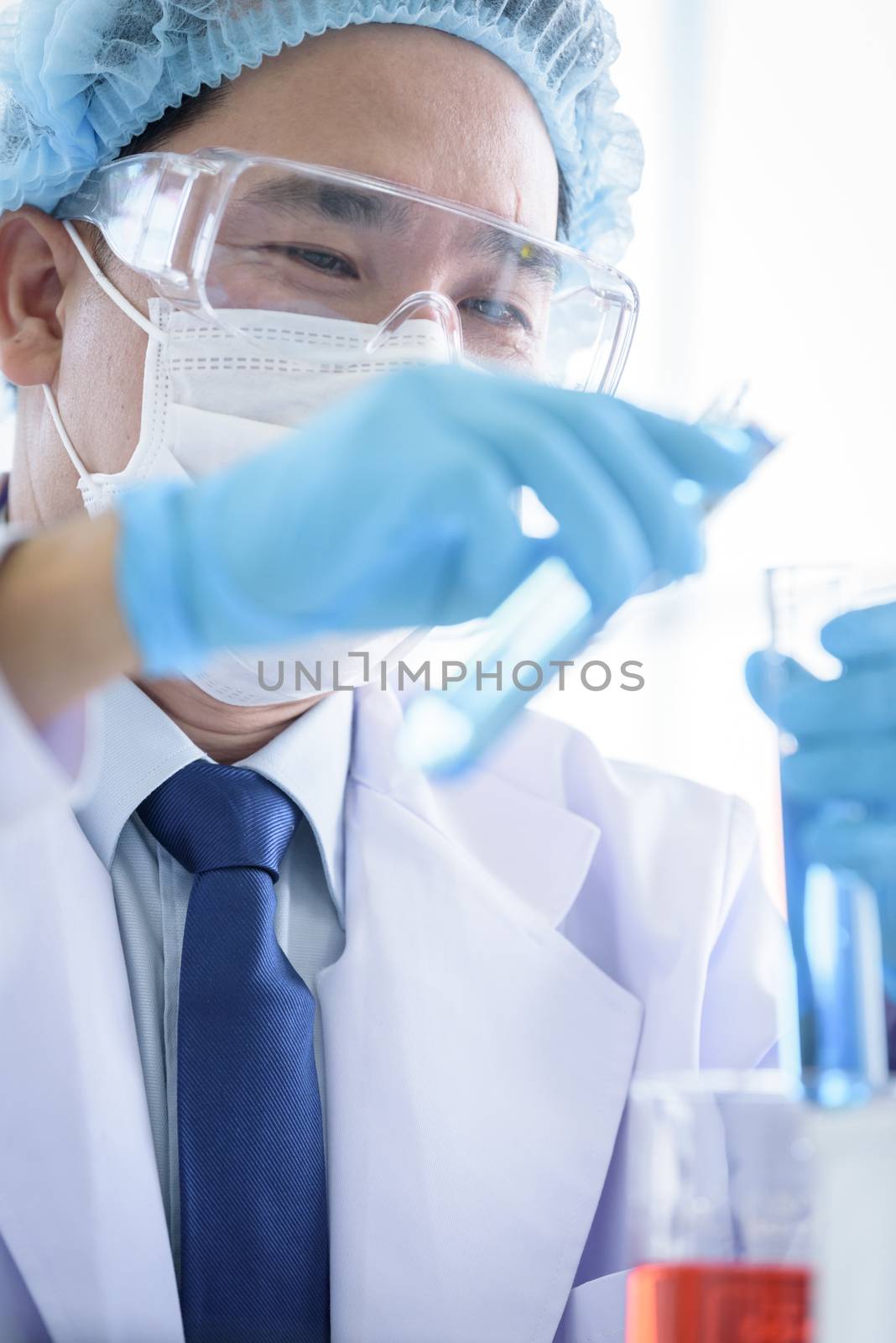 Asian man scientist researching  and learning in a laboratory.