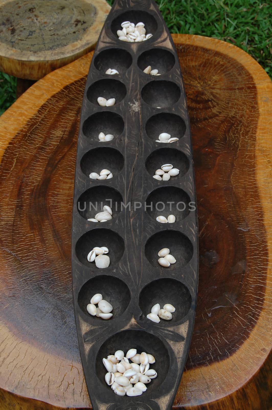 Philippine mancala sungka game consists of wooden board and seed shells