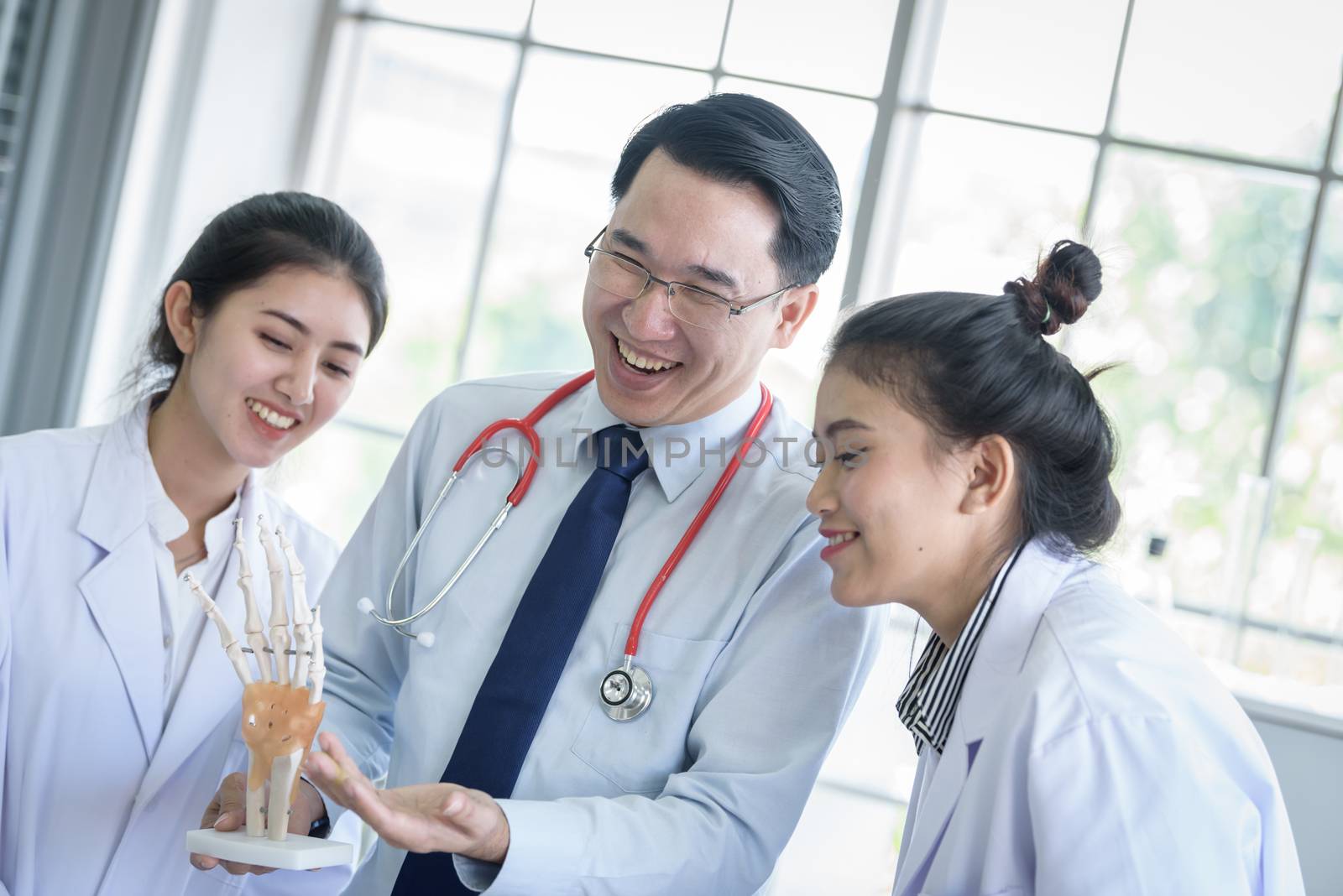 Asian teacher has teaching to student about science and anatomical in laboratory