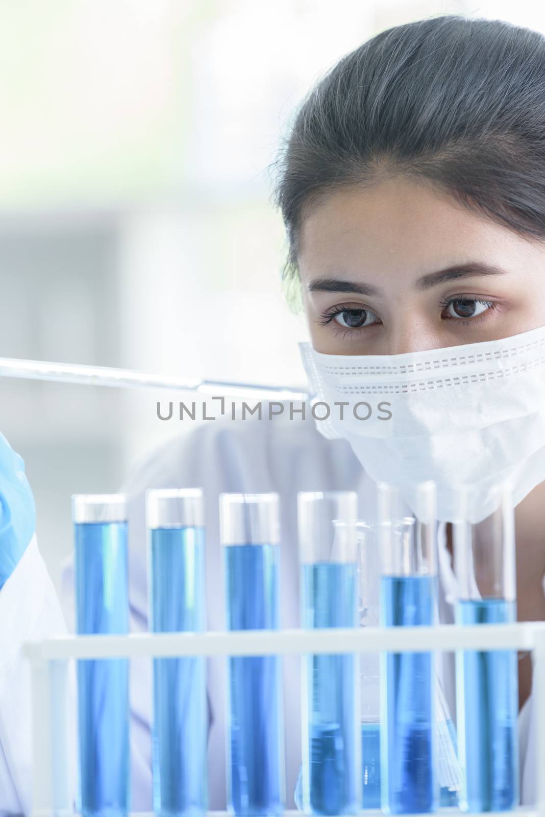 Asian young girl student scientist researching  and learning in a laboratory.