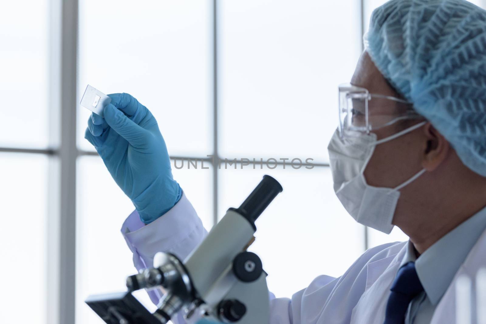 Asian man scientist researching  and learning in a laboratory.