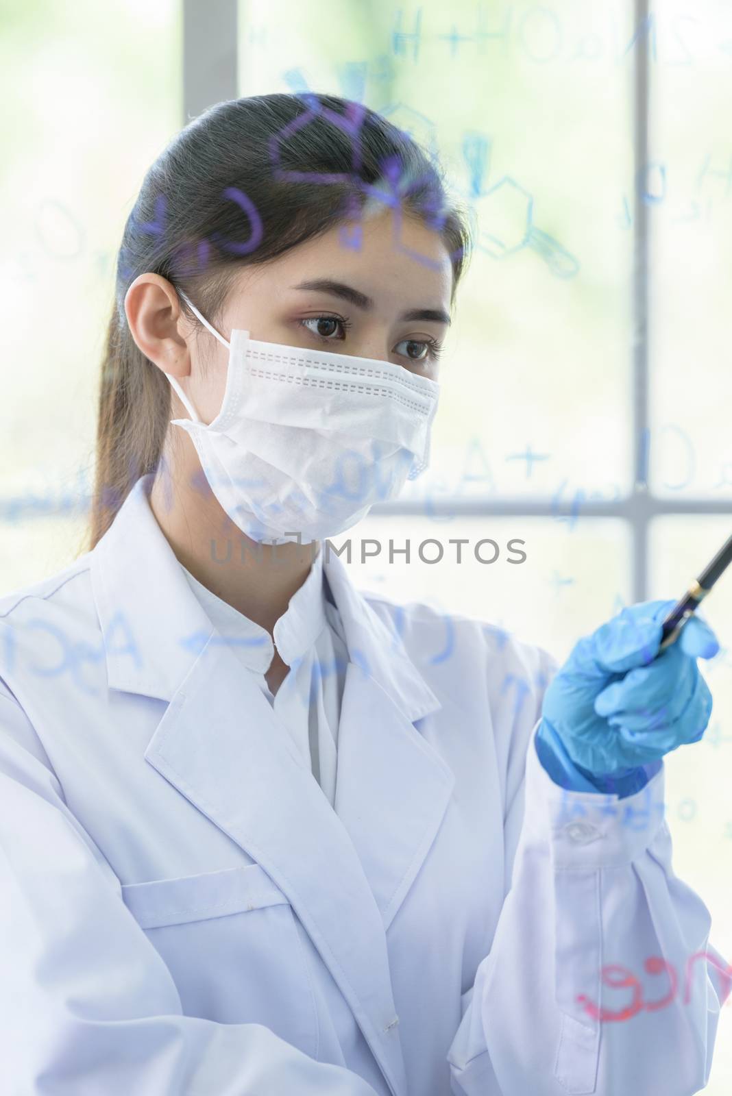 Asian young girl student scientist has writing and researching i by animagesdesign