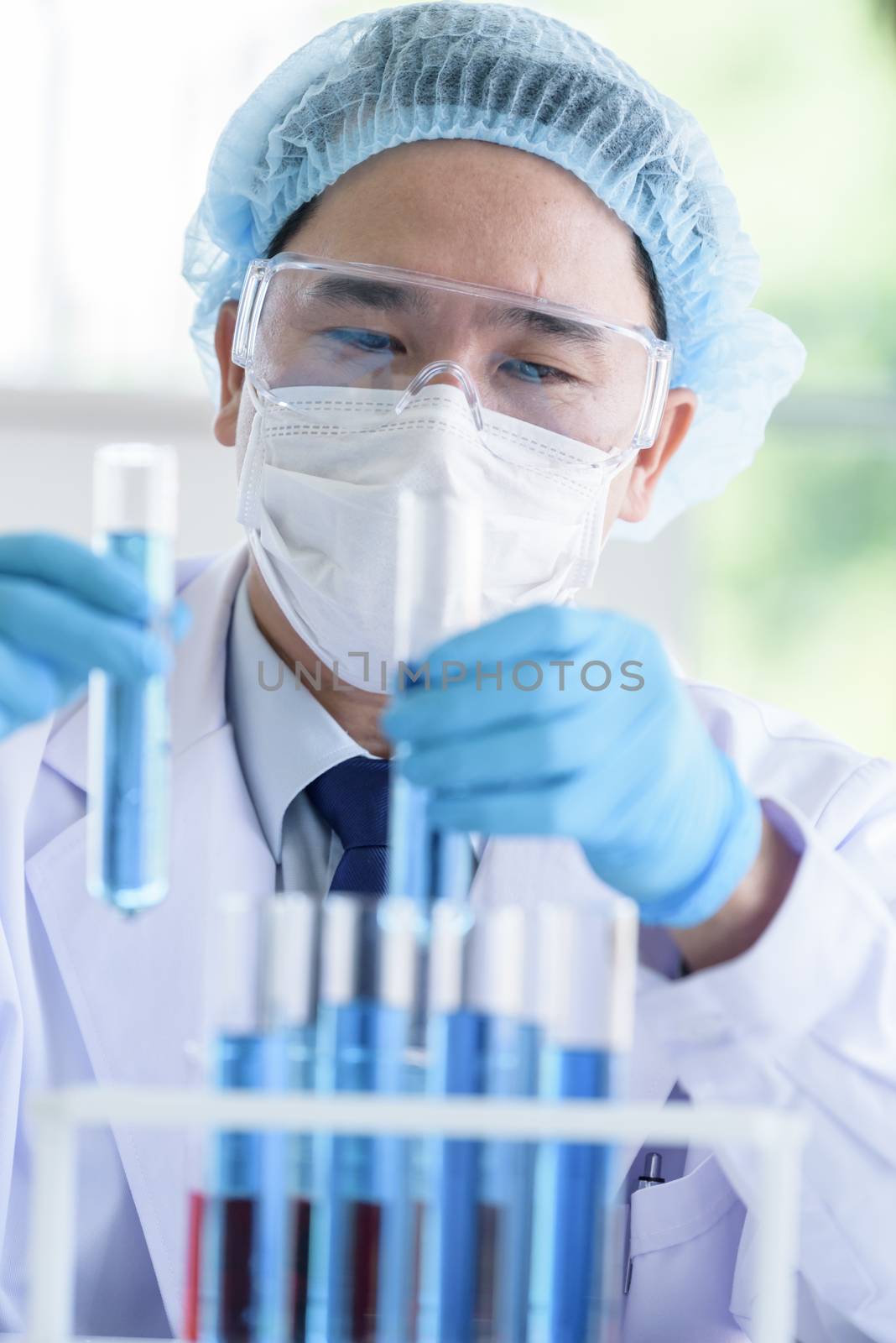 Asian man scientist researching  and learning in a laboratory.