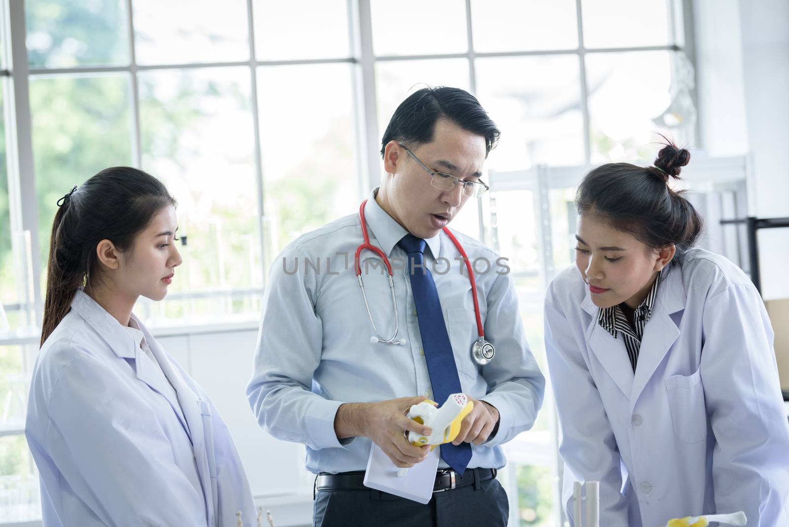 Asian teacher has teaching to student about science and anatomical in laboratory