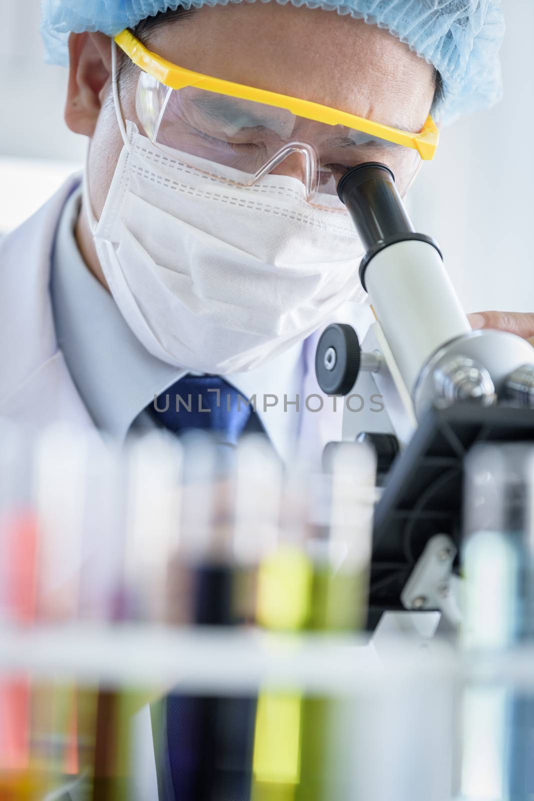 Asian young man student scientist researching  and learning in a laboratory.