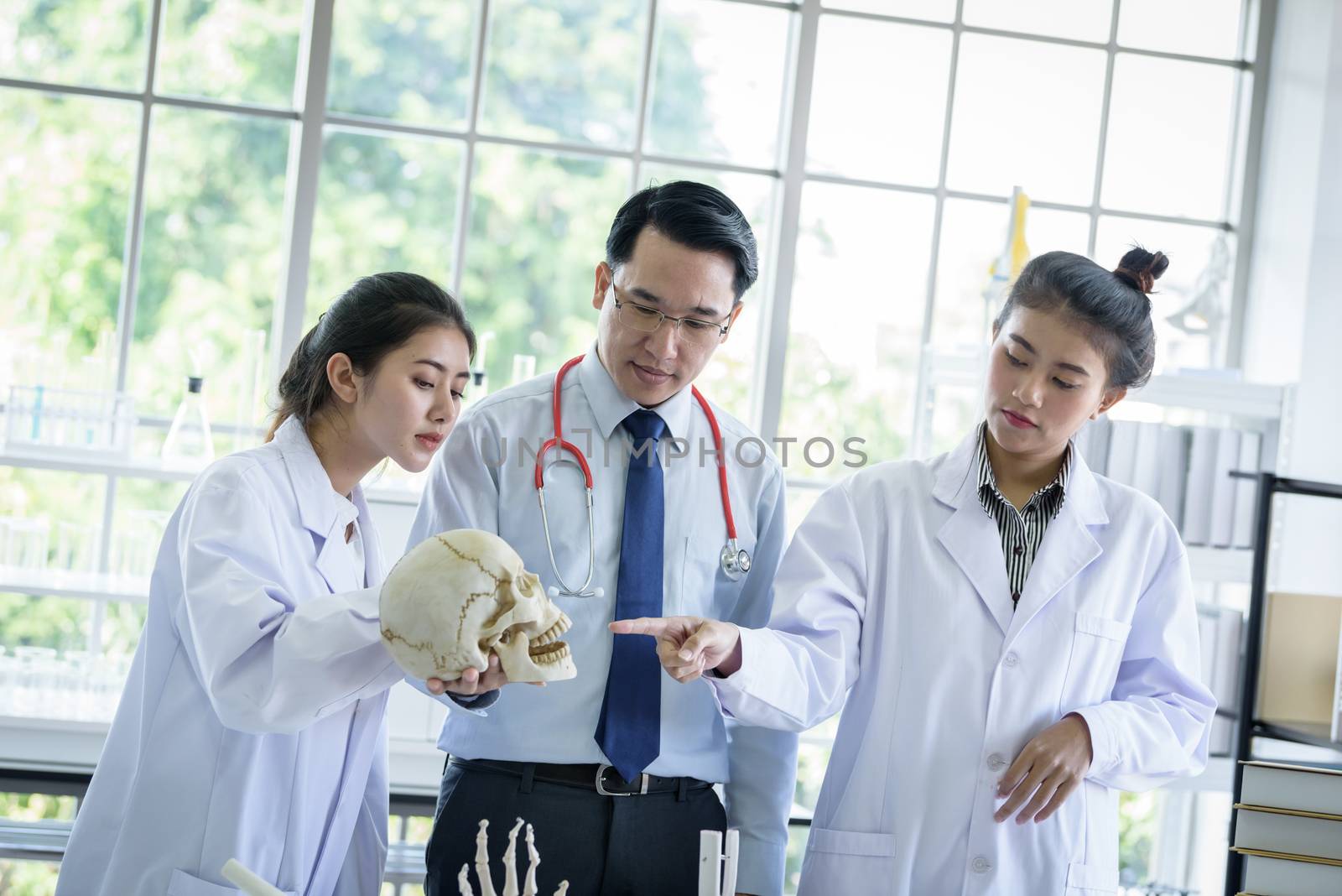 Asian teacher has teaching to student about science and anatomical in laboratory