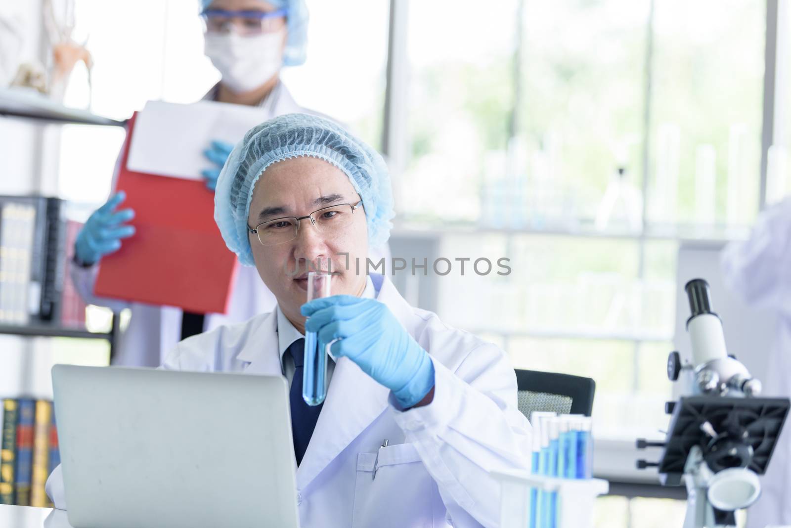 Asian senior scientist male researching and learning in a laboratory.