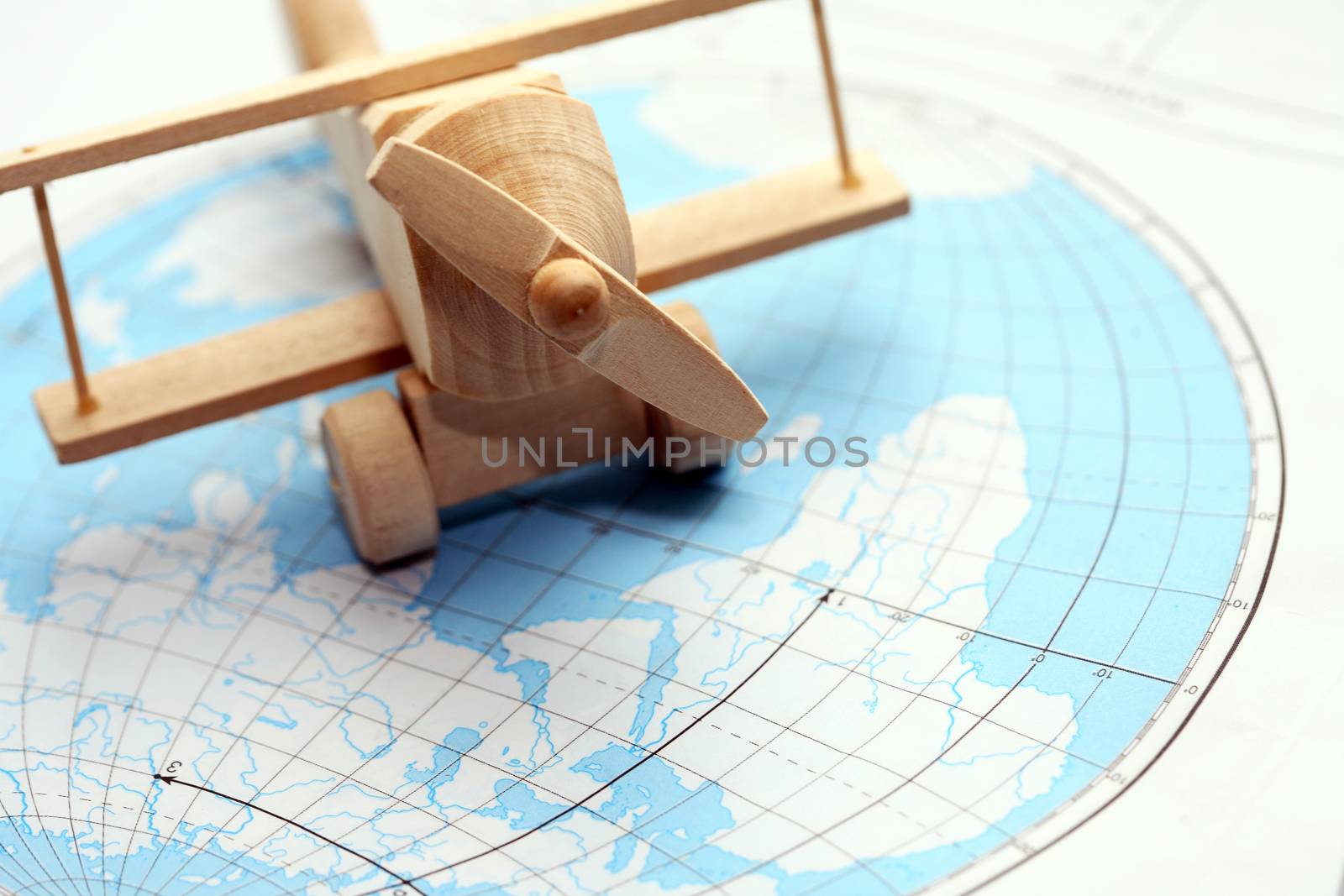 Travel concept. Small wooden airplane on map of world