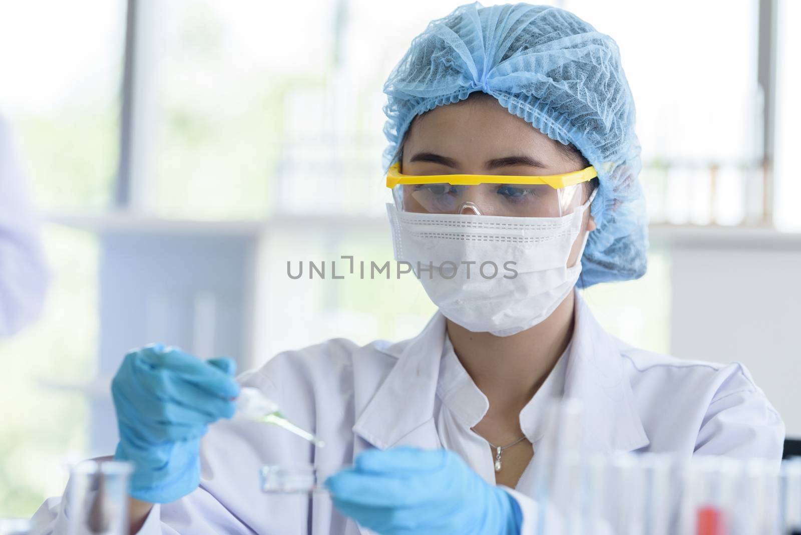 Asian young girl student scientist researching  and learning in a laboratory.