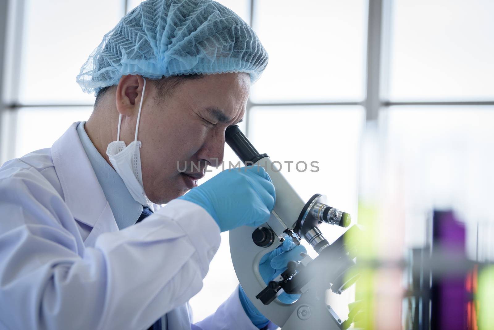 Asian man scientist researching  and learning in a laboratory.