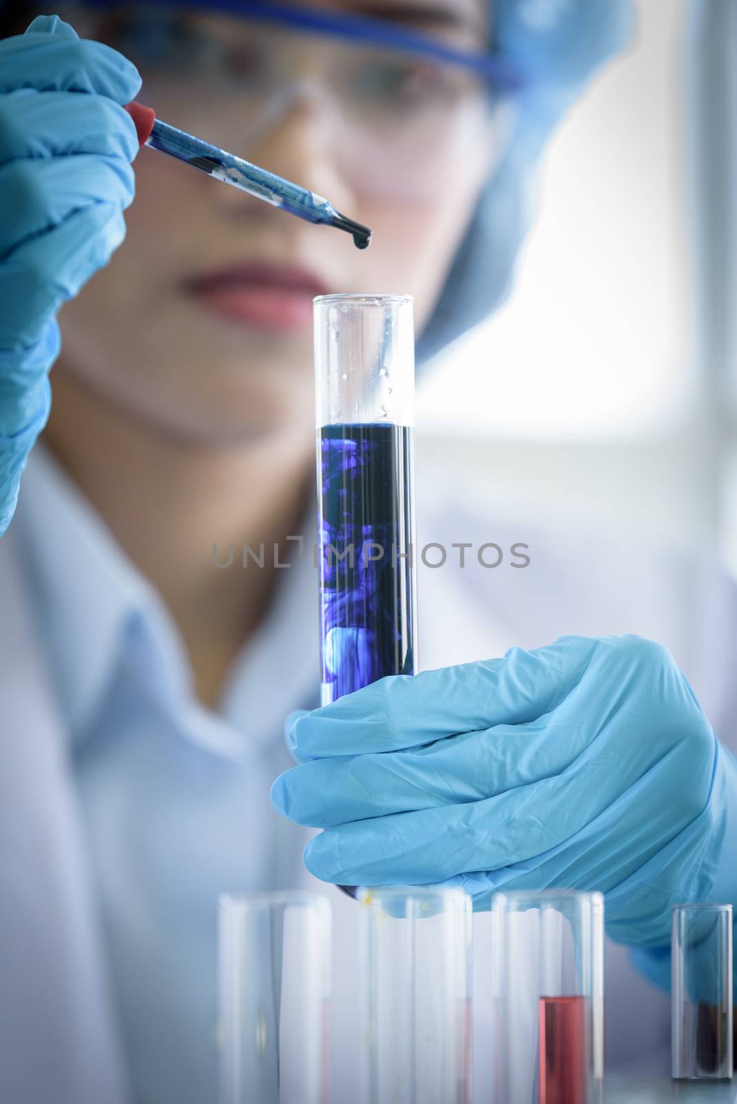 Asian young girl student scientist researching  and learning in a laboratory.