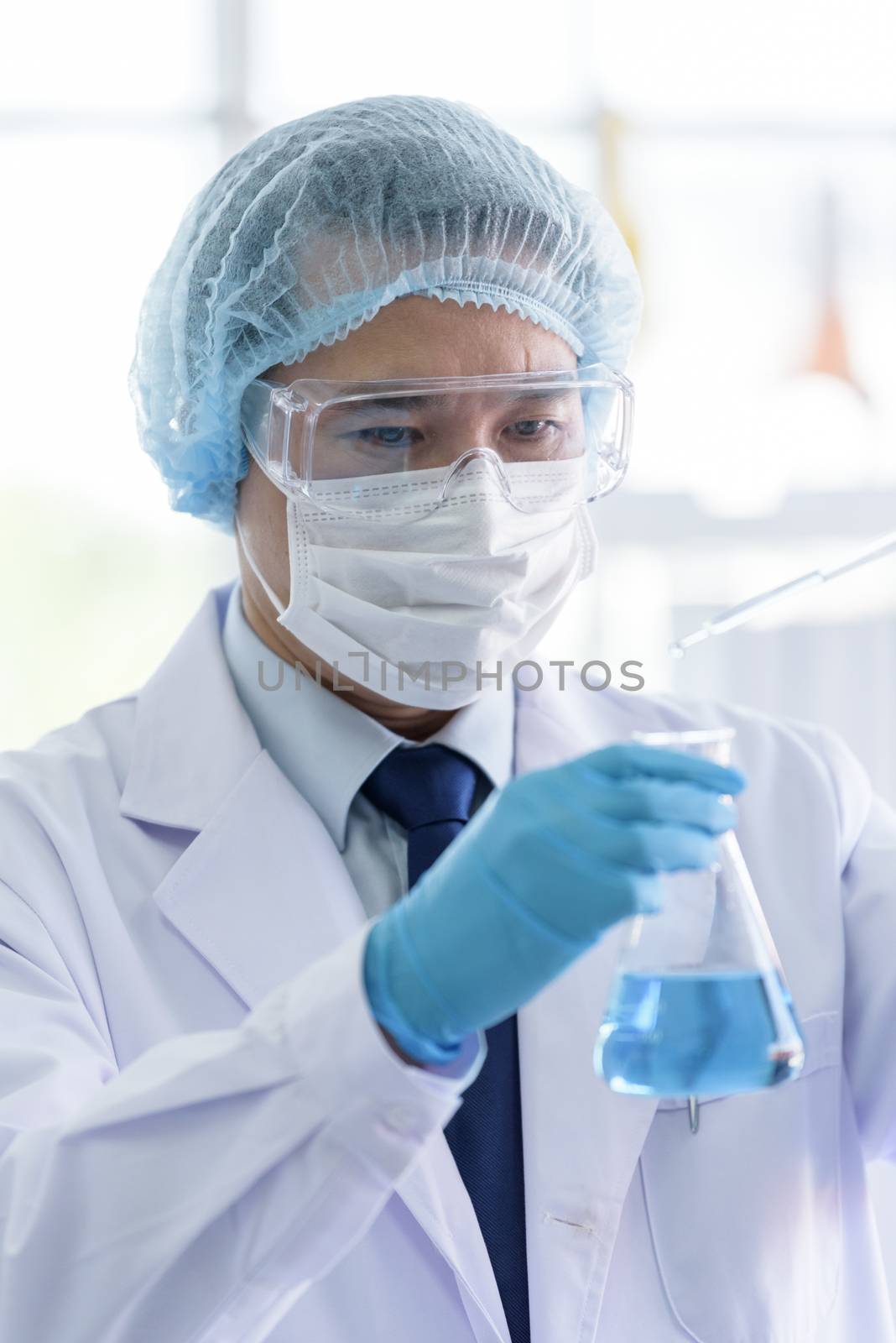 Asian scientist man has researching in laboratory. by animagesdesign