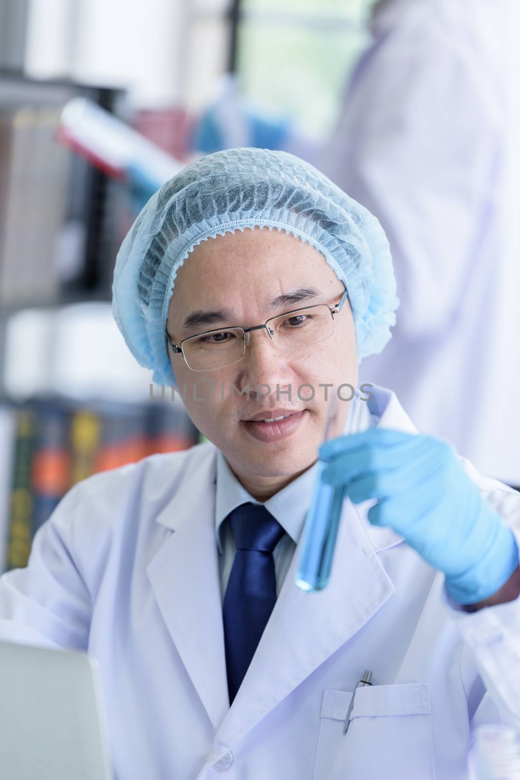 Asian senior scientist male researching and learning in a laboratory.