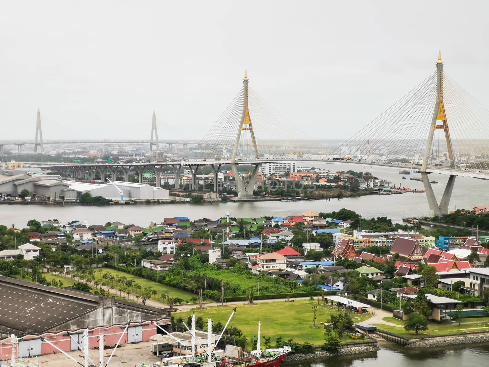 Bhumibol Bridge with river, cityscape view and cloudy sky in the morning.