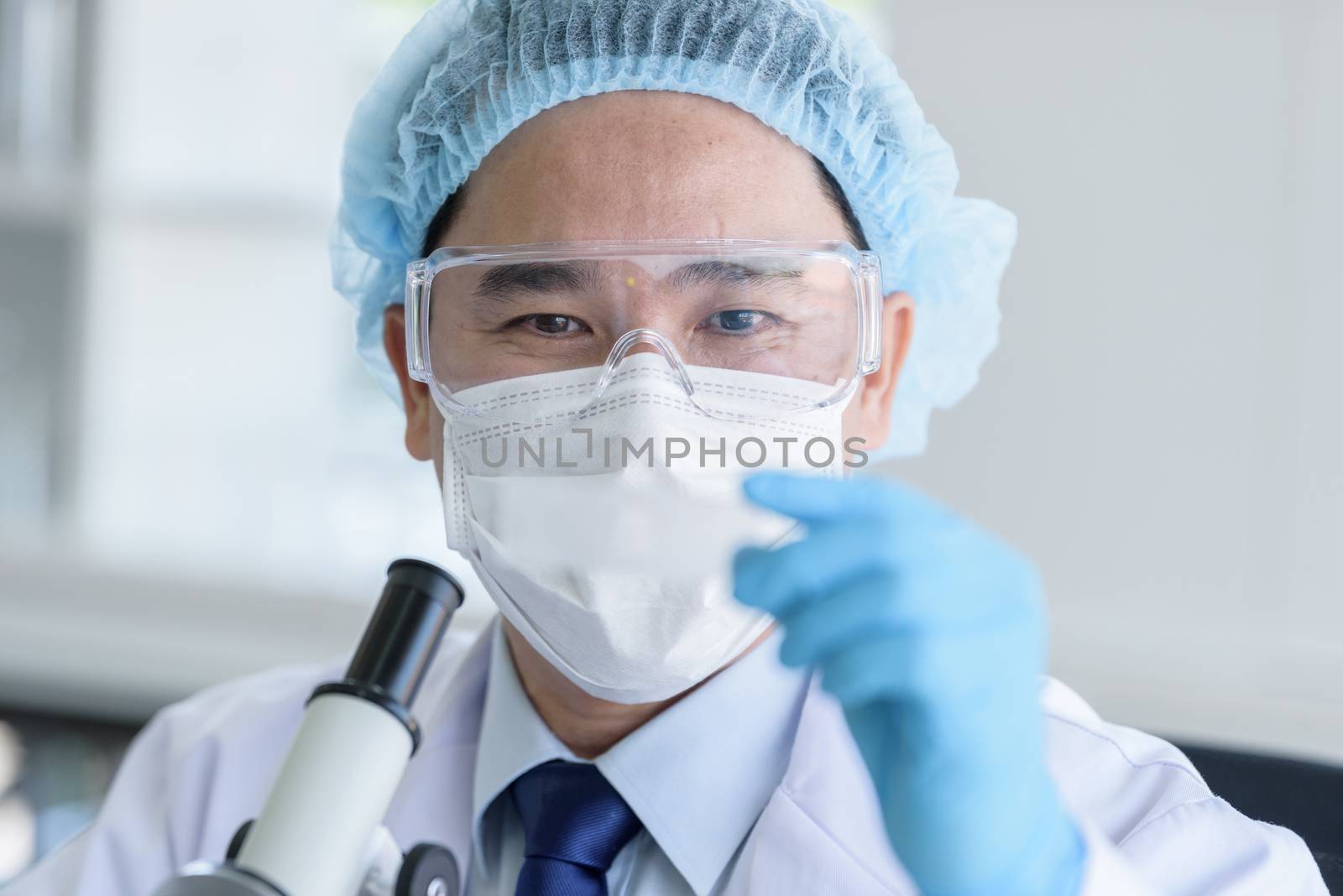 Asian man scientist researching  and learning in a laboratory. by animagesdesign