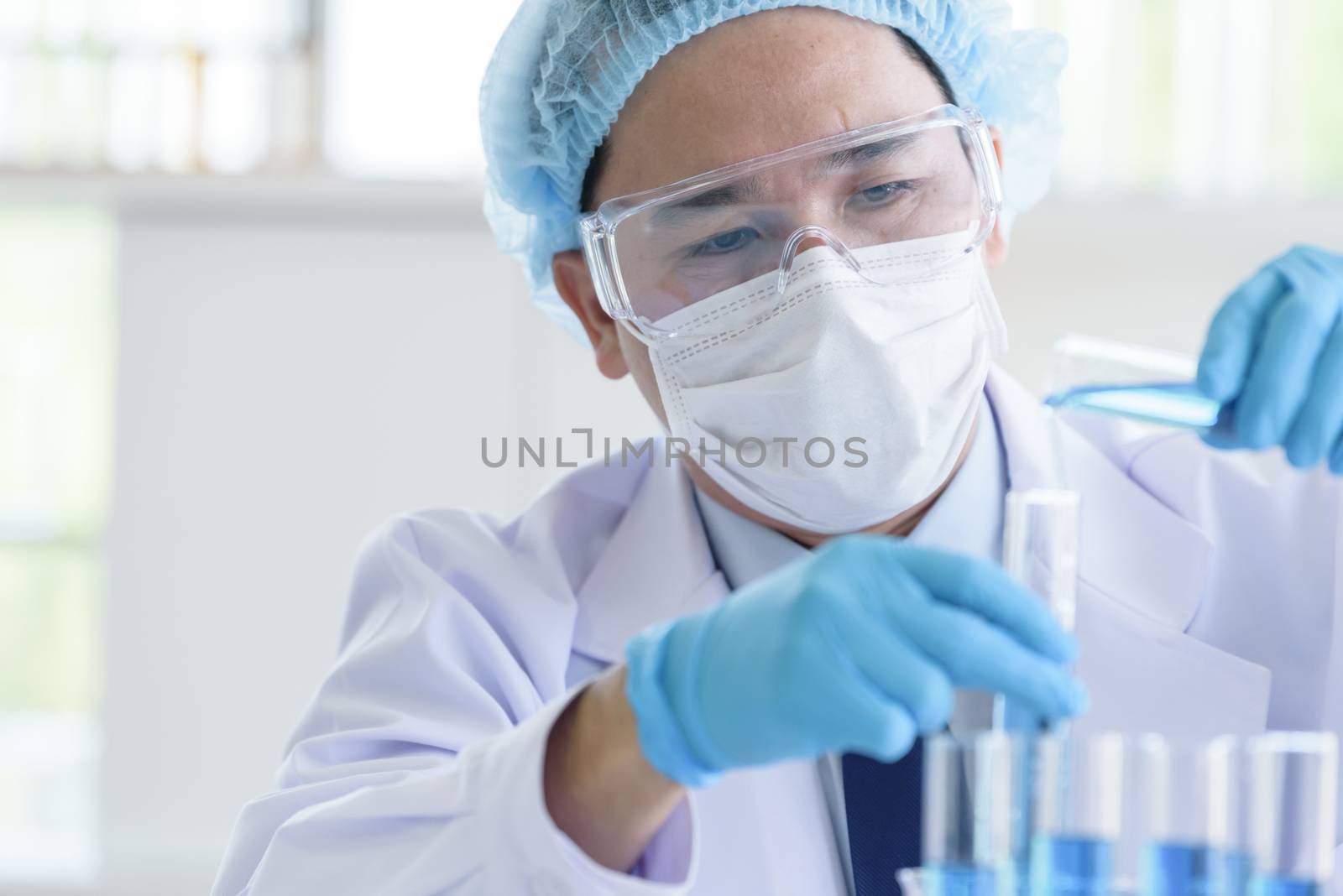 Asian man scientist researching  and learning in a laboratory.