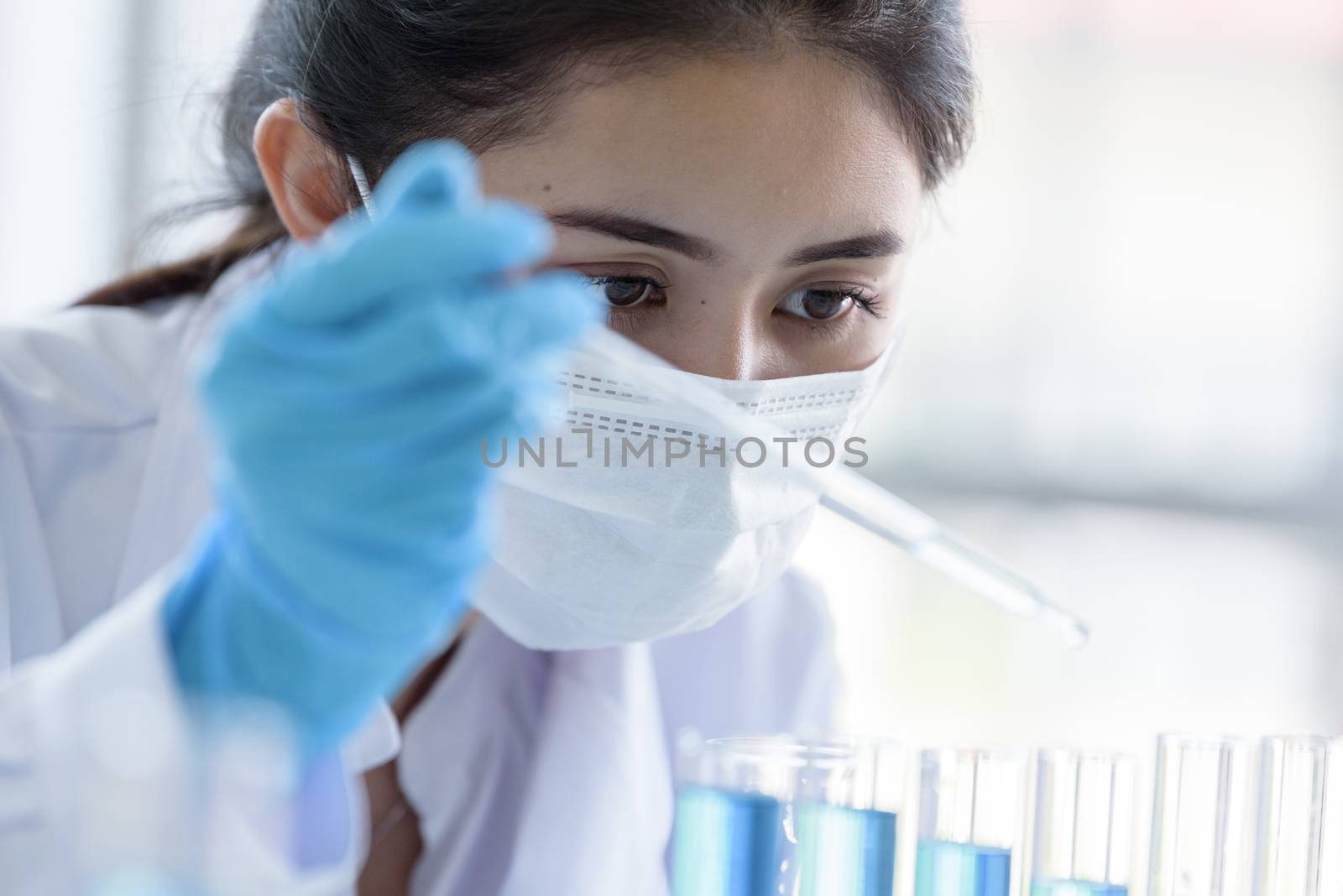 Asian young girl student scientist researching  and learning in a laboratory.