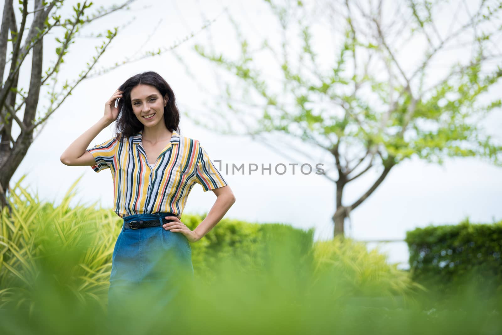 Portrait of a beautiful woman smiling in the garden. by animagesdesign