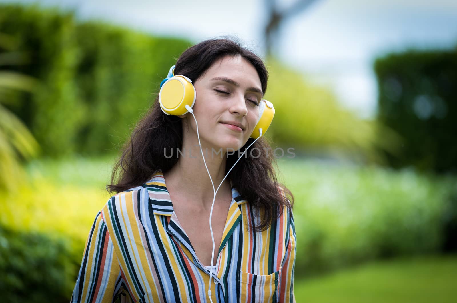 Portrait of a beautiful woman has listening to music with smilin by animagesdesign
