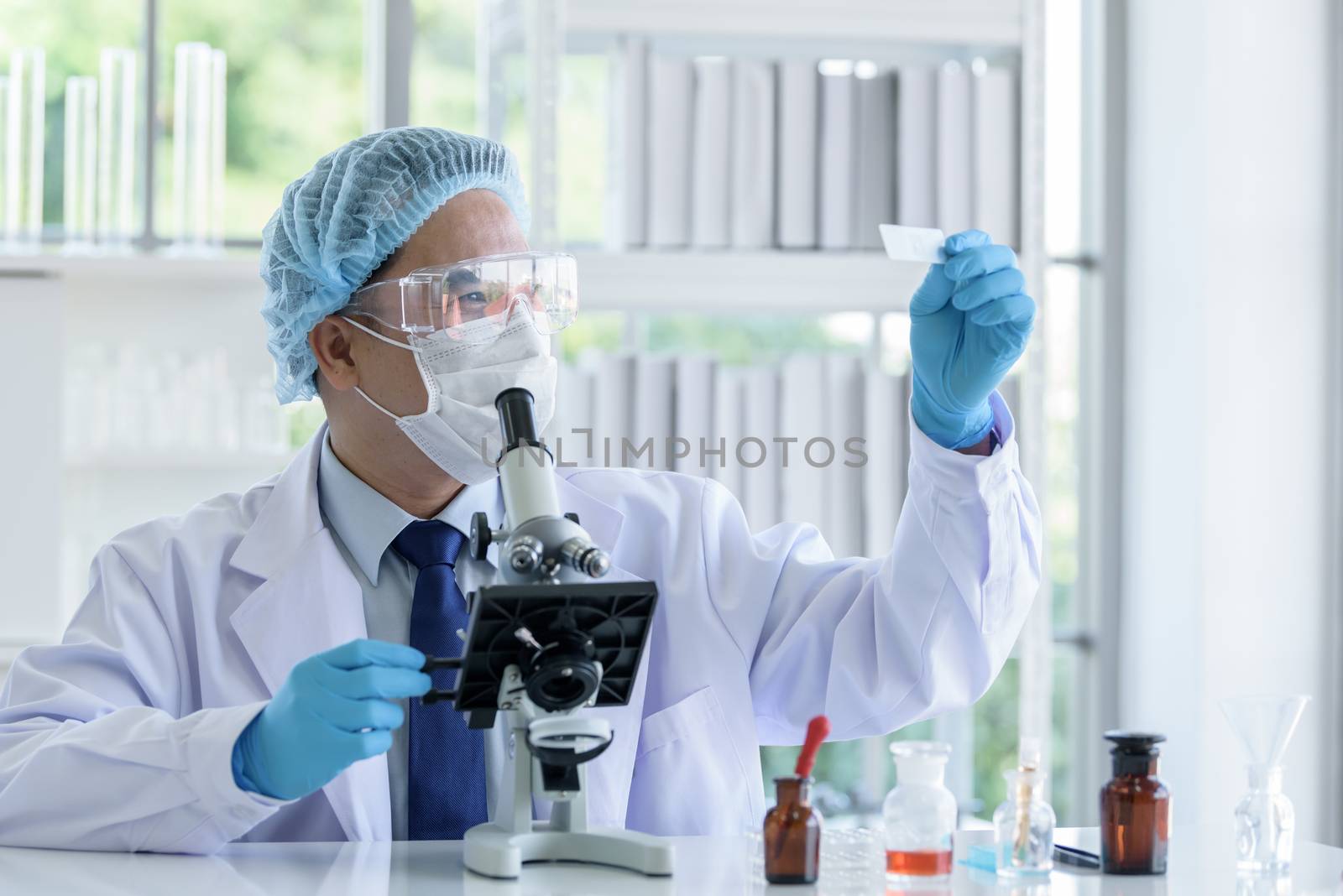 Asian man scientist researching  and learning in a laboratory.