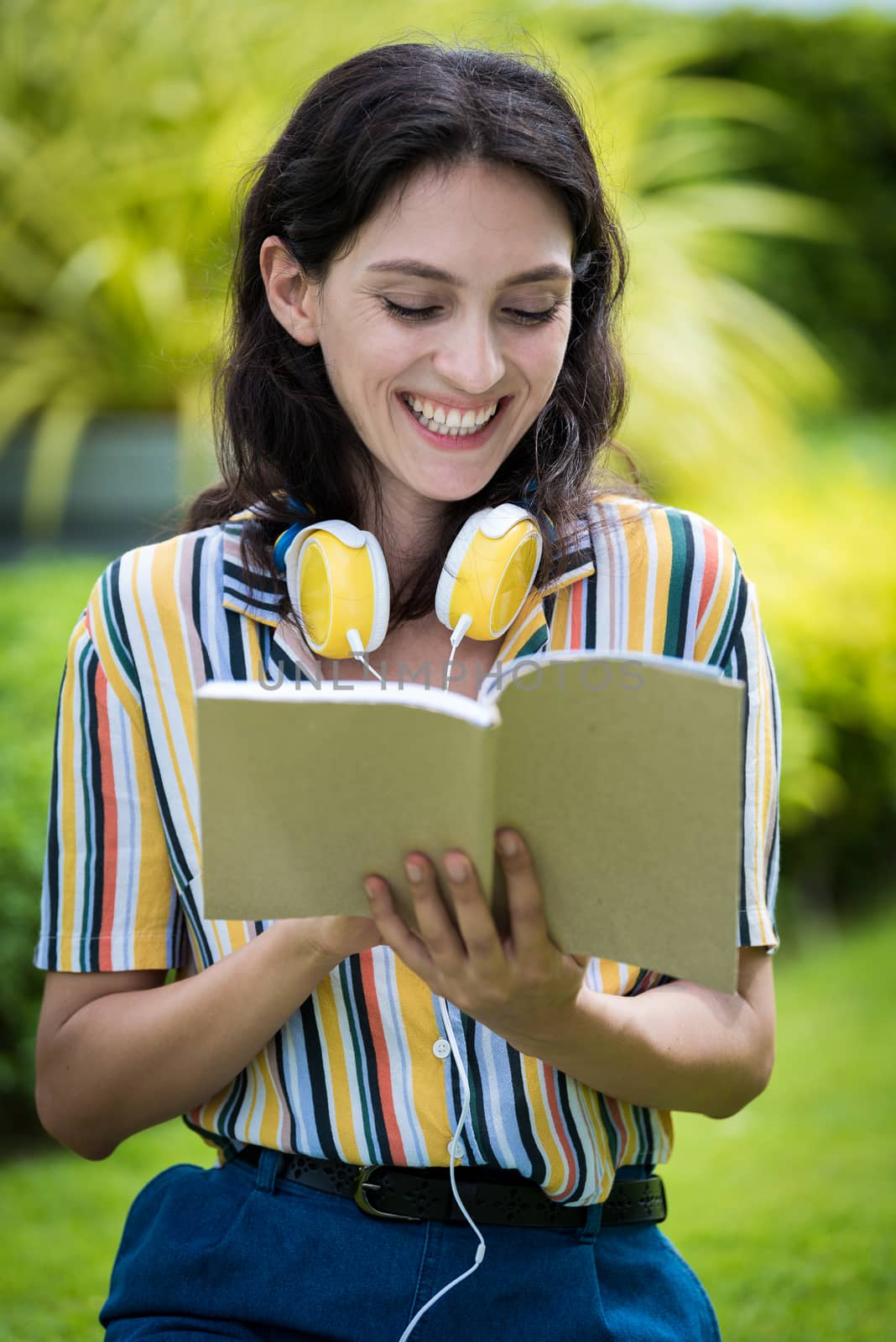 Portrait of a beautiful woman has reading a book with smiling and relax in the garden.