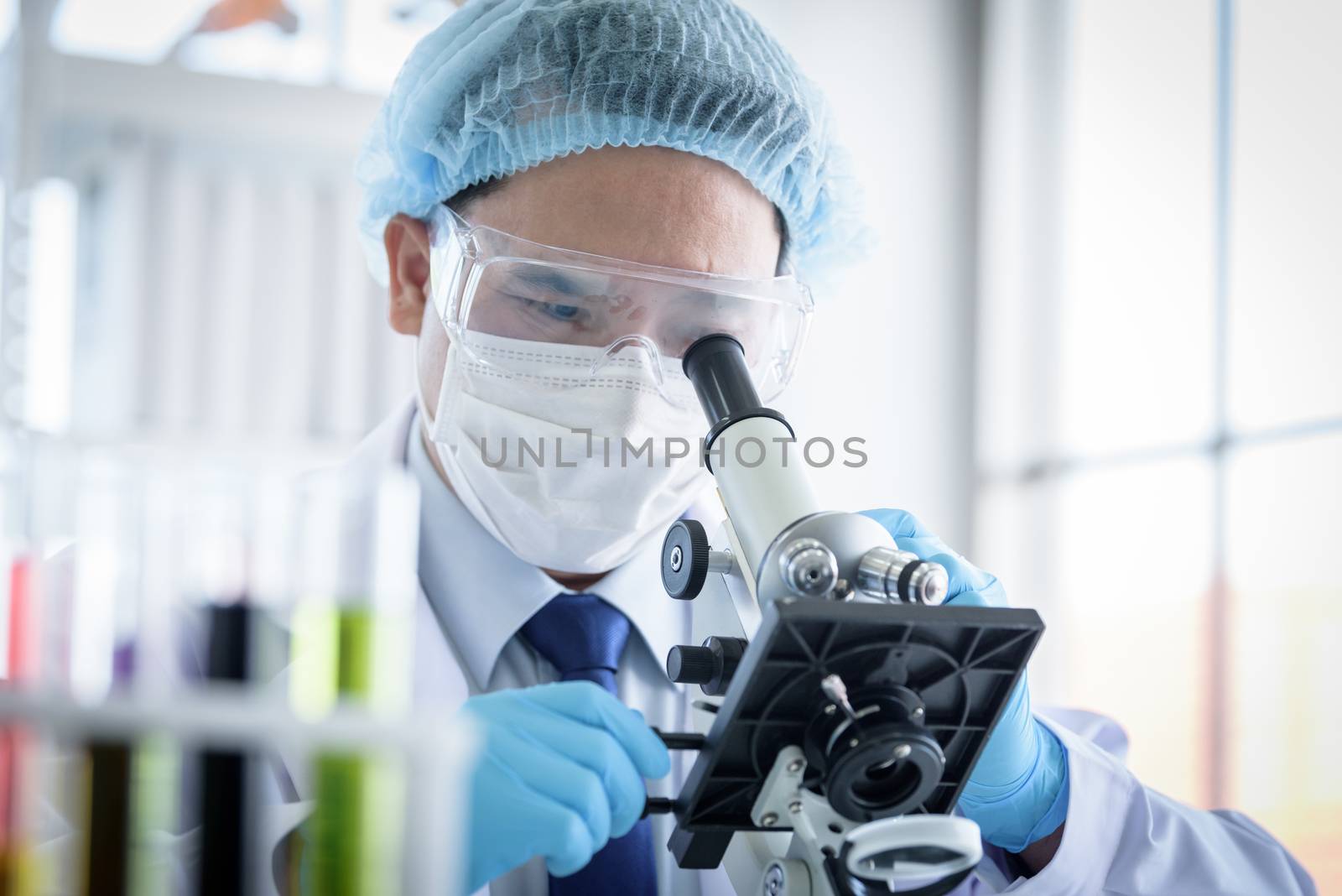 Asian man scientist researching  and learning in a laboratory. by animagesdesign