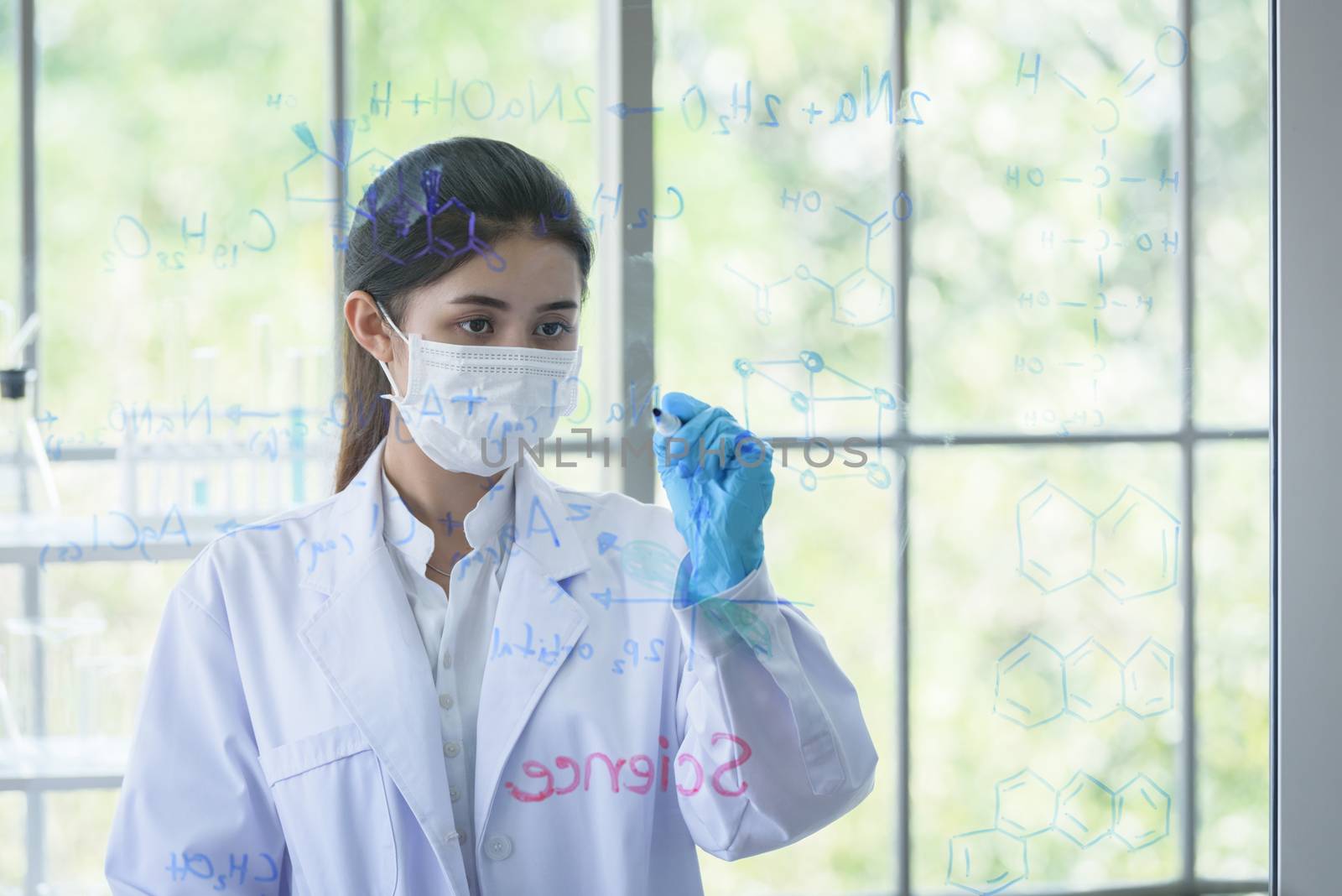 Asian young girl student scientist has writing and researching i by animagesdesign