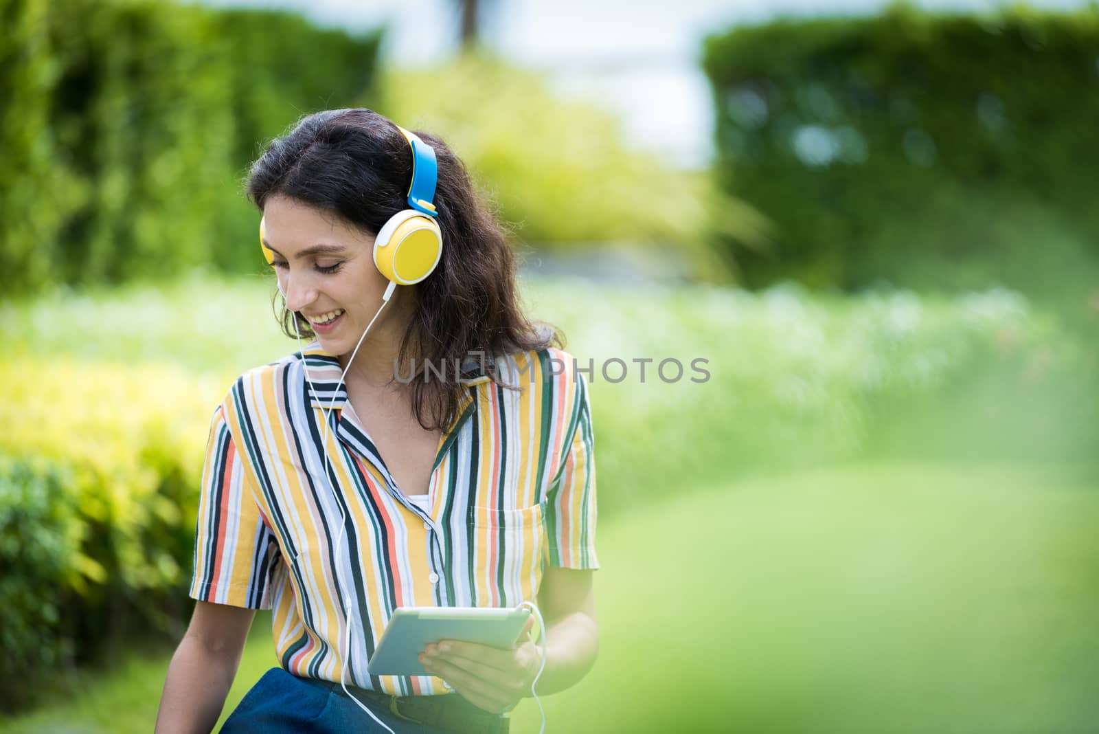 Portrait of a beautiful woman has listening to music with smilin by animagesdesign