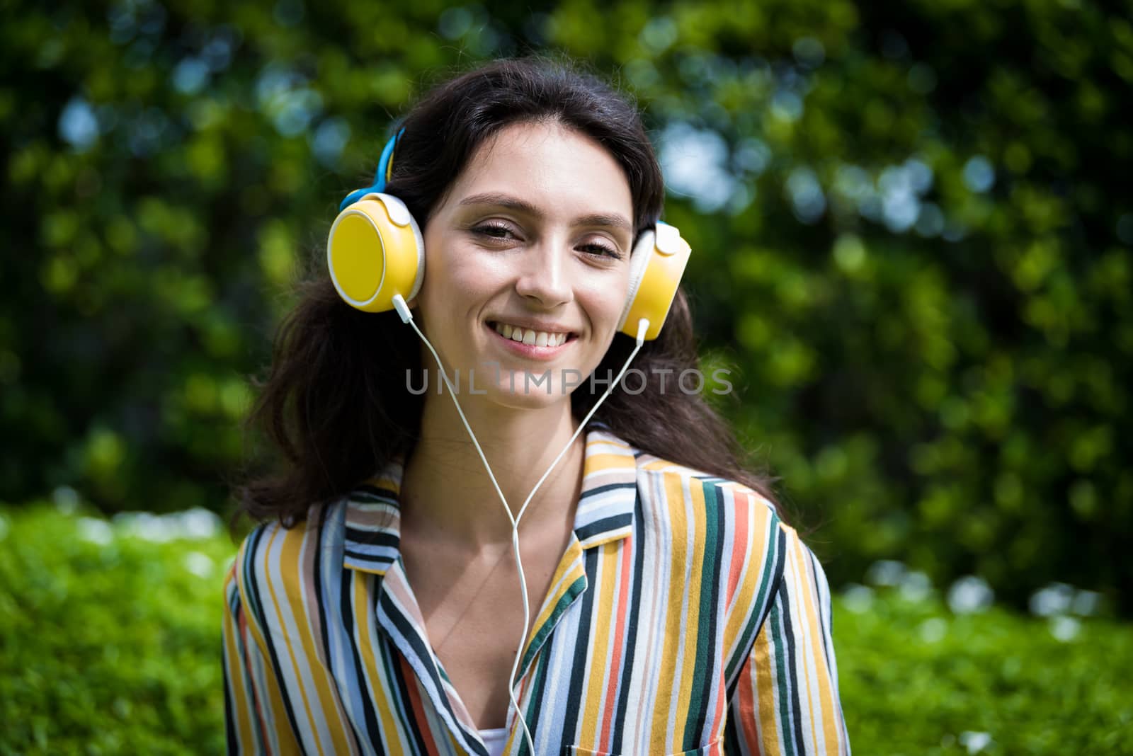 Portrait of a beautiful woman has listening to music with smilin by animagesdesign