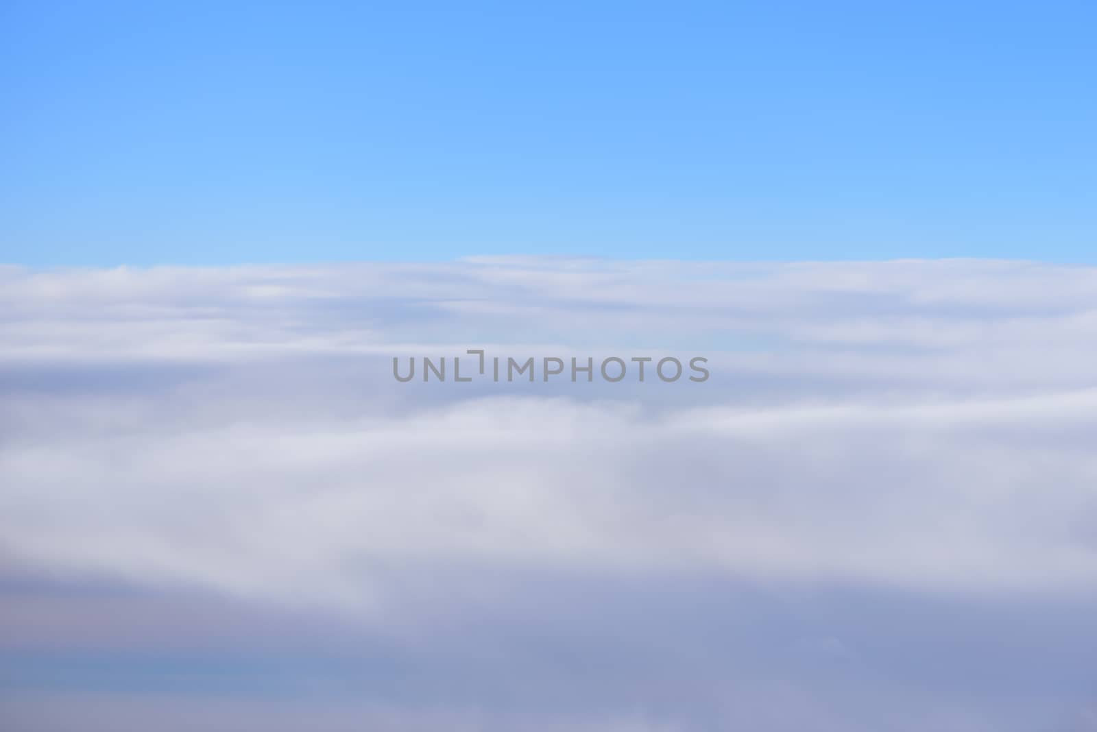 The blue skyline with cloudy in sunrise time, view from window on the plane.