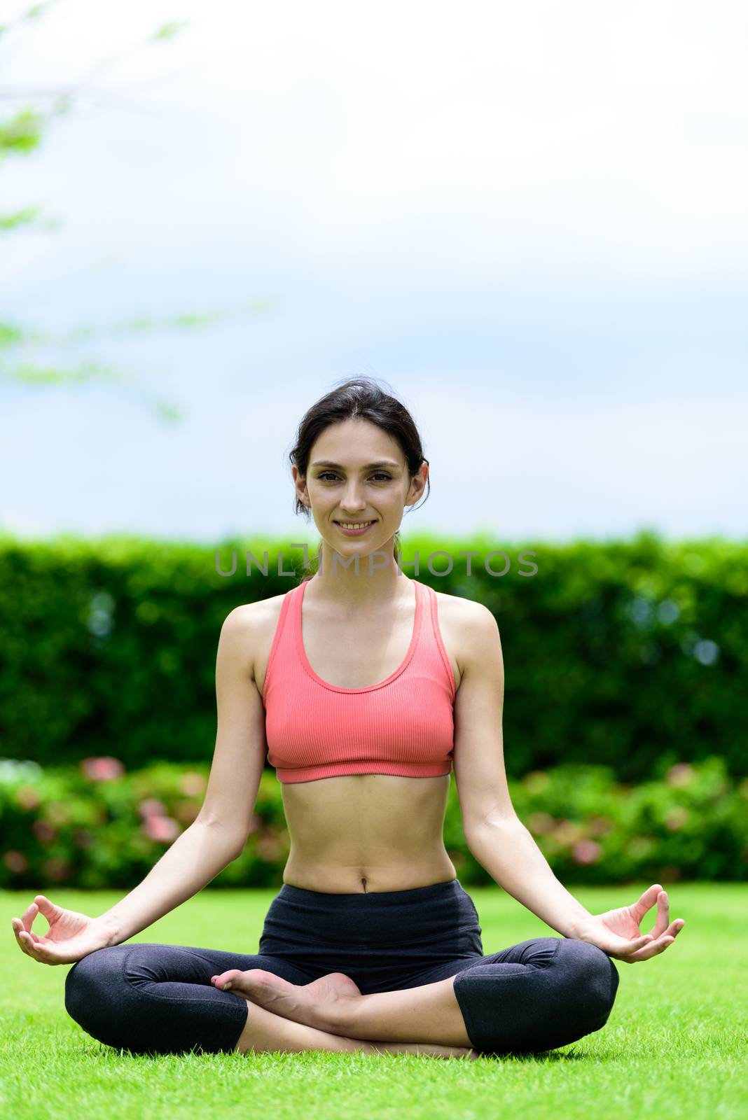 Beautiful woman runner has yoga meditation with peaceful and happy in the garden.