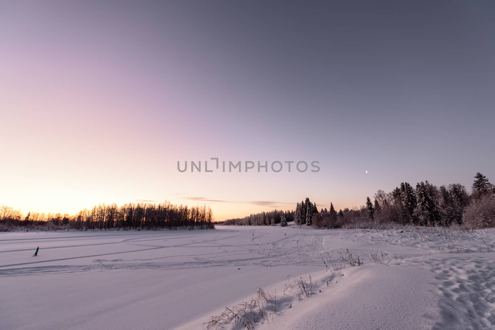 The ice lake and forest has covered with heavy snow and nice blu by animagesdesign