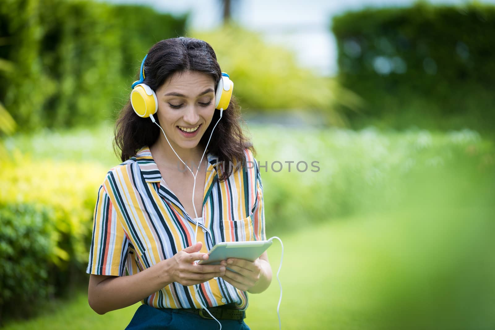 Portrait of a beautiful woman has listening to music with smilin by animagesdesign