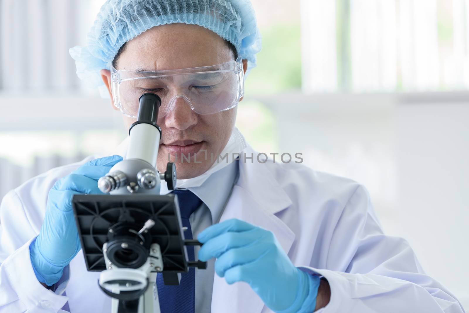 Asian man scientist researching  and learning in a laboratory. by animagesdesign